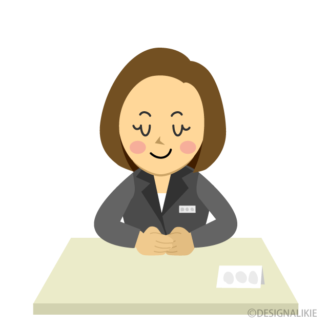 デスクでお辞儀するOL